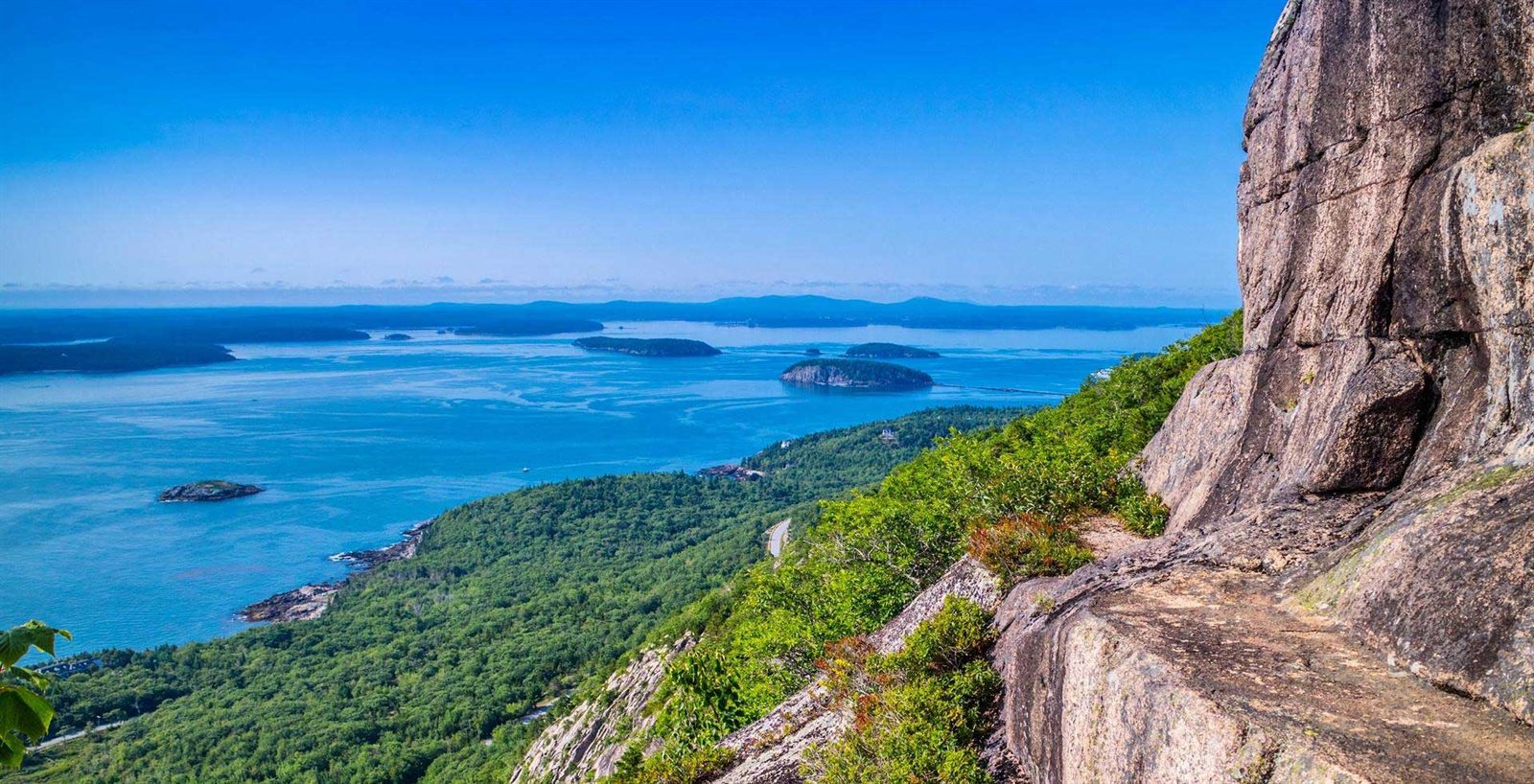 Rocky headland above a blue bay scattered with islands